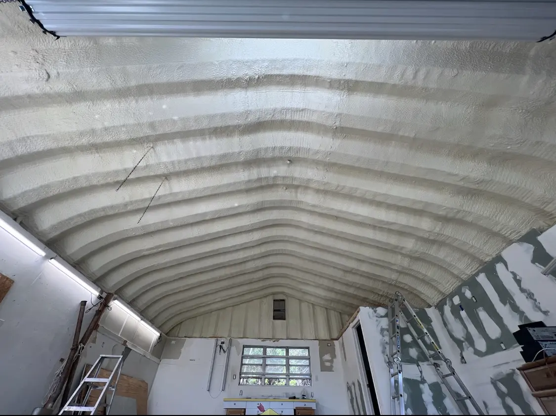 Spray polyurethane foam applied to the underside of a metal roof deck in Richmond West